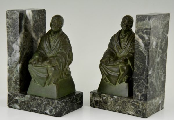 Art Deco bookends buddhist monks reading.