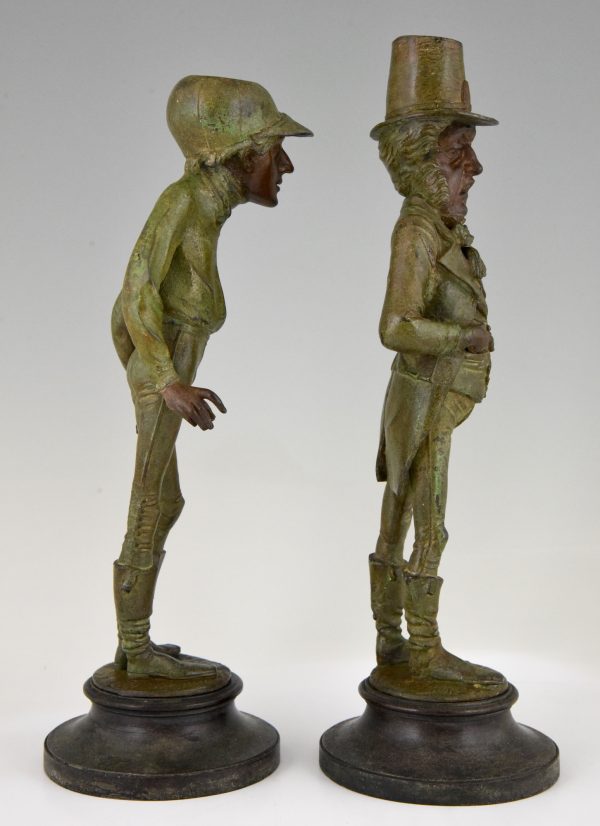A pair of figural candlesticks jockey and gentleman